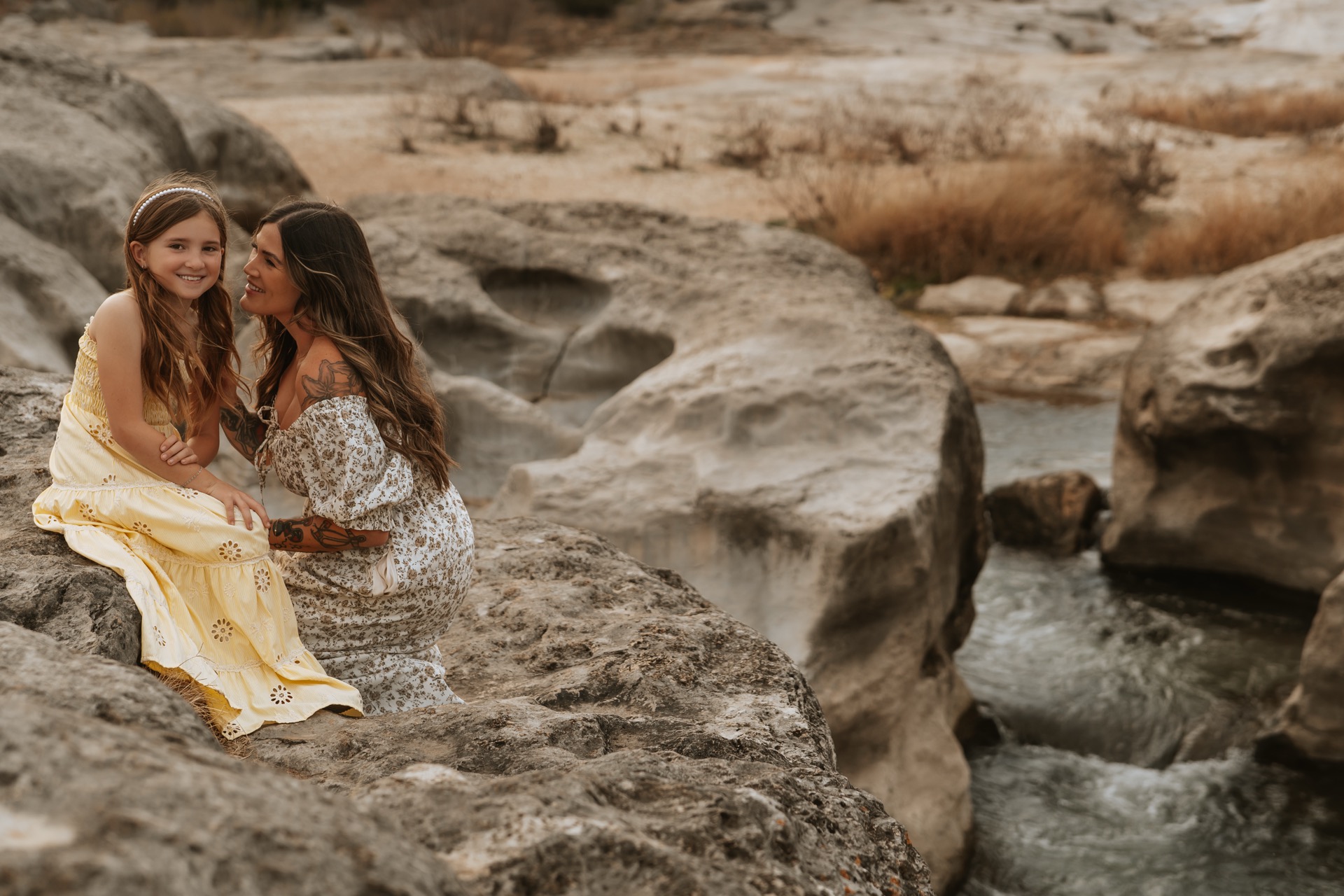 A mother tenderly holds her newborn, captured by Soul Sacred Photography